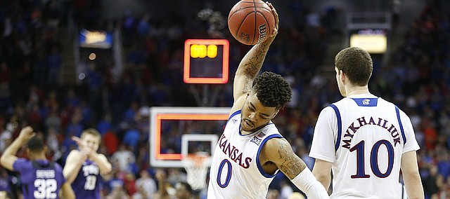 Frustrated, Kansas guard Frank Mason III (0) spikes the ball on the court following the Jayhawks' 85-82 loss to TCU, Thursday, March 9, 2017 at Sprint Center.