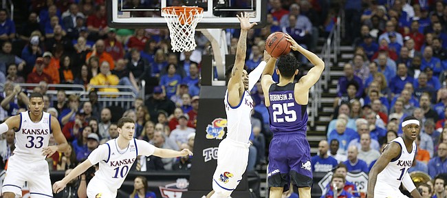 Kansas guard Frank Mason III (0) lunges to defend against a three from TCU guard Alex Robinson (25) during the first half, Thursday, March 9, 2017 at Sprint Center.
