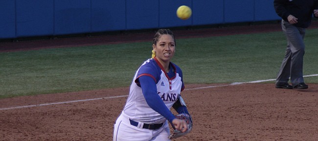 Kansas sophomore pitcher Alexis Reid throws over to first base after fielding a come-backer during the Jayhawks' 5-3 win over UMKC on Thursday at Arrocha Ballpark. Reid earned her ninth win of the season.