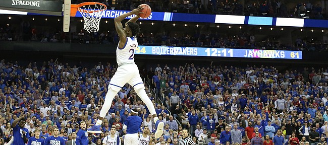 Kansas guard Lagerald Vick (2) spins to deliver a 360 jam on a breakaway during the second half, Thursday, March 23, 2017 at Sprint Center in Kansas City, Mo.