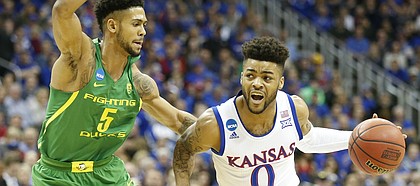 Kansas guard Frank Mason III (0) drives against Oregon guard Tyler Dorsey (5) during the first half on Saturday, March 25, 2017 at Sprint Center.