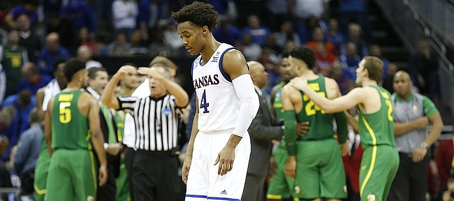 A deflated Kansas guard Devonte' Graham walks to the bench during a KU timeout in the second half on Saturday, March 25, 2017 at Sprint Center.