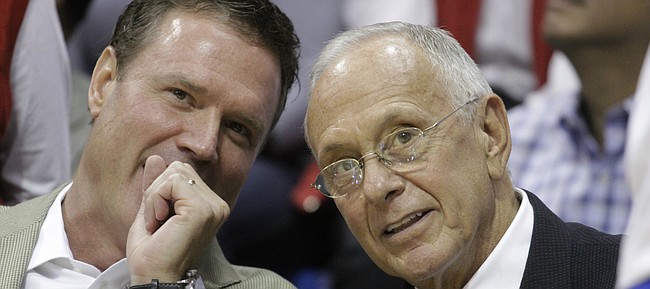Current Kansas University basketball coach Bill Self, left, and former KU coach Larry Brown visit on the bench during the Legends of the Phog game Saturday, Sept. 24, 2011 at Allen Fieldhouse.