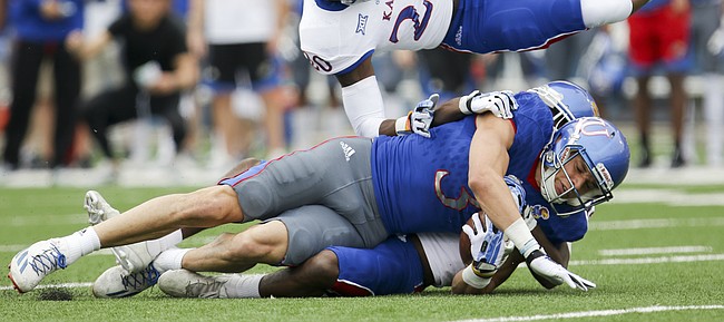 Team KU wide receiver Chase Harrell (3) takes Team Jayhawks safety Emmanuel Moore (20) off of his feet after a catch during the first quarter of the 2017 Spring Game on Saturday, April 15 at Memorial Stadium.