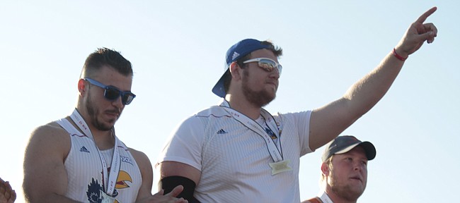 Kansas senior Mitch Cooper holds up the No. 1 after winning the discus throw at the Big 12 Championships on Sunday at Rock Chalk Park. Cooper won the event with a Big 12 record throw of 209 feet, 11 inches. Kansas junior Nicolai Ceban was the runner-up.