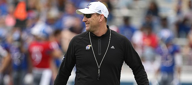 Kansas head coach David Beaty smiles as he walks across the field during the 2017 Spring Game on Saturday, April 15 at Memorial Stadium.