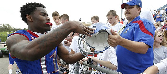 Kansas safety Mike Lee signs autographs following the 2017 Spring Game on Saturday, April 15 at Memorial Stadium.