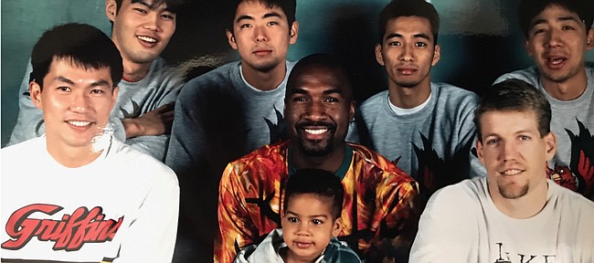 Young Landen Lucas sits with his father, Richard Lucas, for an impromptu team photo during Richard's playing days in Japan. Lucas recently agreed to a professional contract with a Japanese team based in Tokyo.

