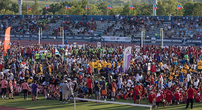 Track and field athletes stop in the infield during the USATF National Junior Olympics opening ceremony on Tuesday, July 25, 2017. More than 8,000 athletes attended the Junior Olympics at Rock Chalk Park. 