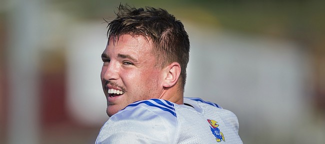 A newly-mustachioed Kansas linebacker Joe Dineen laughs with his teammates during practice on Friday, Aug. 11, 2017 at the practice fields west of Hoglund Ballpark.