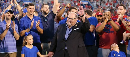 Former Kansas head football coach Mark Mangino and members of the 2008 Orange Bowl team wave to fans as they are recognized during a halftime ceremony, Saturday, Sept. 2, 2017 at Memorial Stadium.