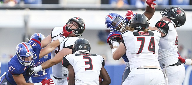 The Kansas defense gets physical while trying to stop Southeast Missouri running back Marquis Terry (3) during the first quarter on Saturday, Sept. 2, 2017 at Memorial Stadium.