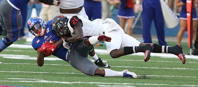 Kansas wide receiver Quan Hampton (6) is hit by Southeast Missouri safety Omar Pierre-Louis (21) after a catch during the second quarter on Saturday, Sept. 2, 2017 at Memorial Stadium.
