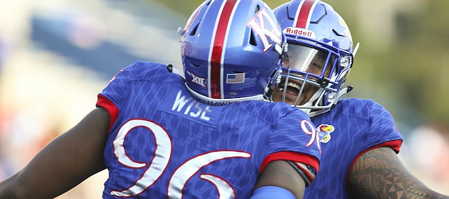 Kansas defensive tackle Daniel Wise (96) and Kansas defensive tackle Isi Holani celebrate a defensive stop during the first quarter on Saturday, Sept. 2, 2017 at Memorial Stadium.