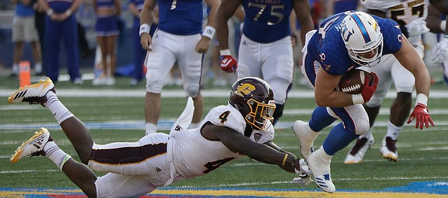 Kansas tight end Ben Johnson slips past a CMU defender during the Jayhawks game against Central Michigan Saturday, Sept. 9 at Memorial Stadium. 