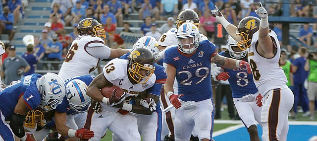 Central Michigan running back Devon Spalding (13) runs past KU defenders for a touchdown in the second-half of CMU’s win over KU Saturday, Sept. 9 at Memorial Stadium. 