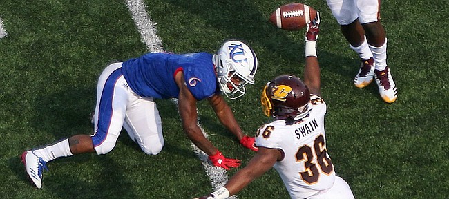 Central Michigan defensive back Tyjuan Swain rips the ball away from Kansas receiver Quan Hampton for an interception on Saturday at Memorial Stadium. 