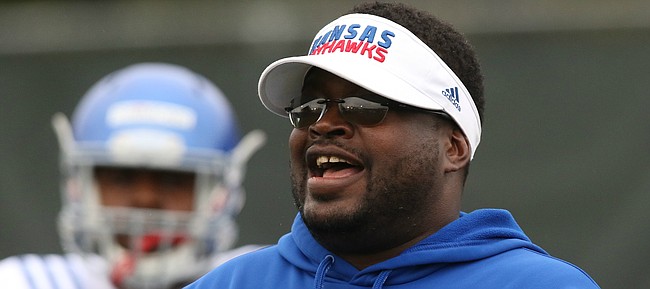 Kansas defensive line coach Jesse Williams flashes a smile during spring football practice on Thursday, March 30, 2017.