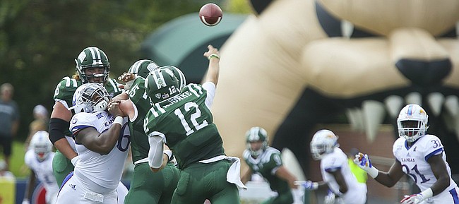 Kansas defensive tackle Daniel Wise (96) is stopped at the line as Ohio quarterback Nathan Rourke (12) throws to a receiver during the first quarter on Saturday, Sept. 16, 2017 at Peden Stadium in Athens, Ohio.