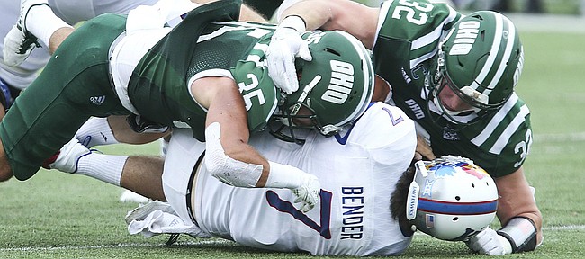 Kansas quarterback Peyton Bender (7) is driven to the turf by Ohio linebacker Dylan Conner (35) and Ohio linebacker Quentin Poling (32) during the third quarter on Saturday, Sept. 16, 2017 at Peden Stadium in Athens, Ohio.