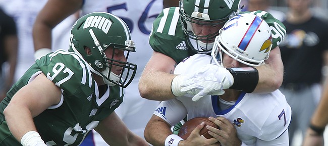 Kansas quarterback Peyton Bender (7) is sacked from behind by Ohio defensive end Trent Smart (90) during the second quarter on Saturday, Sept. 16, 2017 at Peden Stadium in Athens, Ohio.