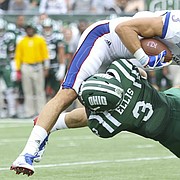 Kansas wide receiver Chase Harrell (3) is taken off of his feet as he is hit by Ohio cornerback Bradd Ellis (3) during the fourth quarter on Saturday, Sept. 16, 2017 at Peden Stadium in Athens, Ohio.