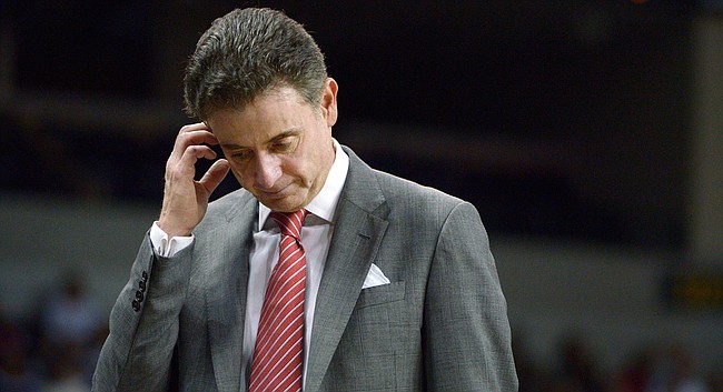 In this Dec. 31, 2013, file photo, Louisville head coach Rick Pitino walks in front of the bench during the second half of an NCAA college basketball game against Central Florida in Orlando, Fla. Louisville announced Wednesday, Sept. 27, 2017, that they have placed basketball coach Rick Pitino and athletic director Tom Jurich on administrative leave amid an FBI probe. (AP Photo/Phelan M. Ebenhack, File)

