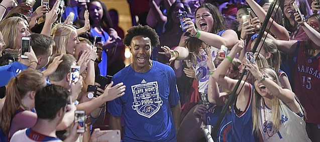 Kansas senior guard Devonte' Graham walks down the aisle during his team's introductions in the 33rd-annual Late Night in the Phog on Saturday, Sept. 30, 2017 at Allen Fieldhouse. 