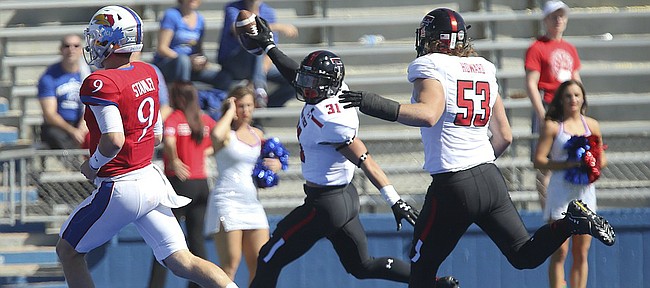 Kansas quarterback Carter Stanley (9) can't stop Texas Tech defensive back Justus Parker (31) as he runs into the end zone for a touchdown during the third quarter after an interception on Saturday, Oct. 7, 2017 at Memorial Stadium.