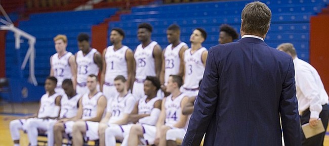 Kansas head coach Bill Self watches off camera while his players are positioned for a players-only team portrait during Media Day on Friday, Oct. 13, 2017 at Allen Fieldhouse. Members of the men's basketball team were available for photographs and interviews with various media outlets.
