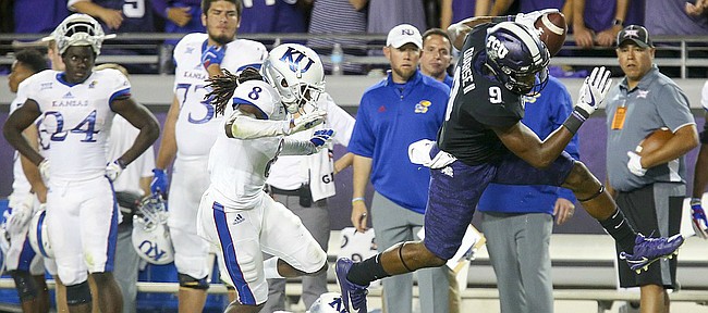 TCU wide receiver John Diarse (9) escapes Kansas cornerback Shakial Taylor (8) and Kansas safety Mike Lee (11) for a touchdown during the second quarter, Saturday, Oct. 21, 2017 at Amon G. Carter Stadium in Fort Worth.