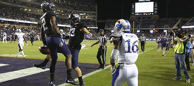 Kansas cornerback Kyle Mayberry (16) watches as TCU wide receiver Taj Williams (2) and TCU wide receiver Ty Slanina (13) celebrate Williams' touchdown catch during the third quarter, Saturday, Oct. 21, 2017 at Amon G. Carter Stadium in Fort Worth.