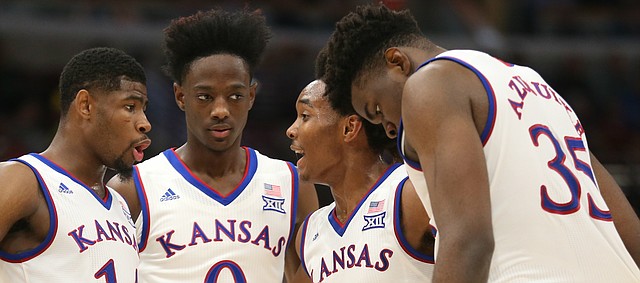 Kansas guard Devonte' Graham (4) pulls his teammates together in a huddle during the first half on Tuesday, Nov. 14, 2017 at United Center.