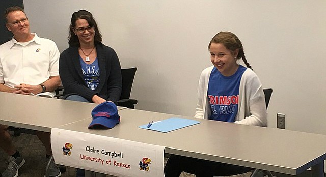 Free State senior Claire Campbell, right, laughs during her signing ceremony in the school's conference room Wednesday. Campbell signed to swim at Kansas. 