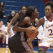 Kansas senior Chayla Cheadle (22) and junior Christalah Lyons (0) cut off the lane to the basket for Texas Southern's Breasia McElrath during the Jayhawks' 72-37 win on Wednesday at Allen Fieldhouse.