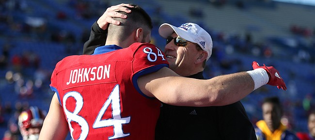 Kansas head coach David Beaty gives a hug to senior tight end Ben Johnson during the Senior Day ceremony on Saturday, Nov. 18, 2017 at Memorial Stadium.