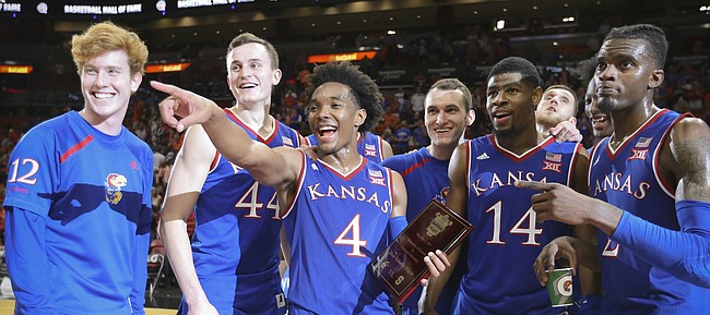 Kansas guard Devonte' Graham (4) holds the MVP trophy as he and the Jayhawks acknowledge the KU fans following their 76-60 win over Syracuse, Saturday, Dec. 2, 2017 at American Airlines Arena in Miami.