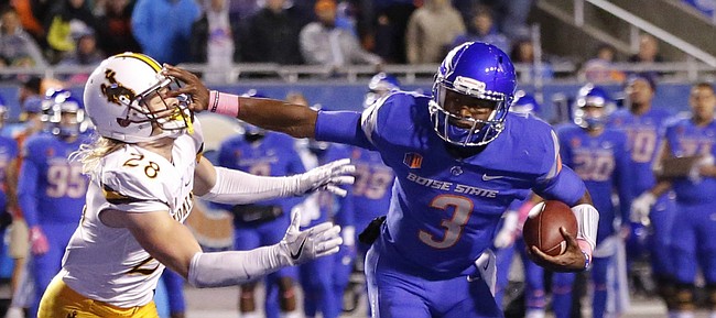 Boise State quarterback Montell Cozart (3) runs the ball against Wyoming safety Andrew Wingard (28) during the second half of an NCAA college football game in Boise, Idaho, Saturday, Oct. 21, 2017. Boise State won 24-14. (AP Photo/Otto Kitsinger)

