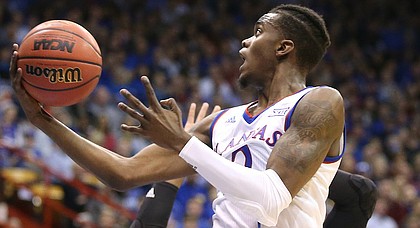 Kansas guard Lagerald Vick (2) swoops in for a shot during the first half on Monday, Dec. 18, 2017 at Allen Fieldhouse.