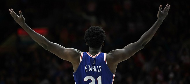 Philadelphia 76ers center Joel Embiid gestures to the crowd after being shoved by Utah Jazz's Donovan Mitchell during the second half of an NBA basketball game, Monday, Nov. 20, 2017, in Philadelphia. Mitchell was called for a technical foul on the play. Philadelphia won 107-86. 

