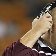 FILE — Louisiana Monroe interim head coach John Mumford adjust his headphones while walking off the field during a injury time out in the first quarter of an NCAA college football game against Hawaii, Saturday, Nov. 28, 2015, in Honolulu. A Lawrence native, Mumford will wrap up his first season as defensive line coach at New Mexico State at Friday's Arizona Bowl. (AP Photo/Eugene Tanner)