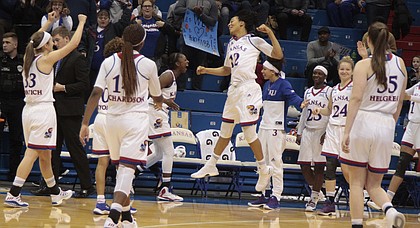 The Kansas women's basketball team celebrates its 86-77 win over TCU in its Big 12 home opener on Sunday at Allen Fieldhouse.