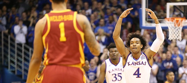 Kansas guard Devonte' Graham (4) raises up the Fieldhouse as Iowa State guard Nick Weiler-Babb (1) brings the ball up the court during the first half, Tuesday, Jan. 9, 2018.