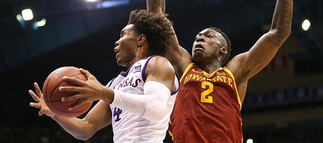 Kansas guard Devonte' Graham (4) gets to the bucket past Iowa State forward Cameron Lard (2) during the second half, Tuesday, Jan. 9, 2018 at Allen Fieldhouse.