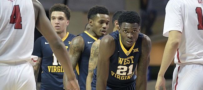 West Virginia forward Wesley Harris (21) sets up for a play in front of Marist forward Isaiah Lamb (4) and forward Aleksandar Dozic, right, during the second half of an NCAA college basketball game at the AdvoCare Invitational tournament Thursday, Nov. 23, 2017, in Lake Buena Vista, Fla. West Virginia won 84-78. 