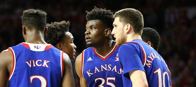 Kansas players huddle around Kansas center Udoka Azubuike (35) before a one-and-one during the second half at Lloyd Noble Center on Tuesday, Jan. 23, 2018 in Norman, Oklahoma.