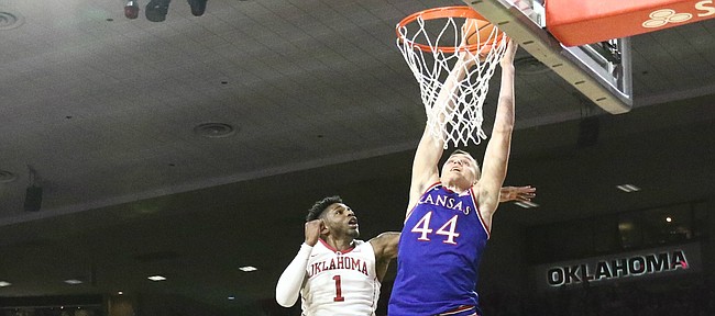Kansas forward Mitch Lightfoot (44) comes in for a dunk against Oklahoma guard Rashard Odomes (1) during the first half at Lloyd Noble Center on Tuesday, Jan. 23, 2018 in Norman, Oklahoma.