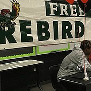 Free State football players sign their letters of intent during a ceremony Wednesday in the school's Black Box Theatre. From left, Jalan Robinson (undecided), Gabe Clark (Central Missouri), Tanner Cobb (Baker), Nathan Spain (Baker), Gage Foster (Baker), David Johnson (Emporia State) and Spencer Roe (Kansas). 