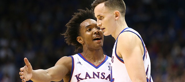 Kansas guard Devonte' Graham (4) talks with Kansas forward Mitch Lightfoot (44) during a break in action in the second half on Tuesday, Feb. 6, 2018 at Allen Fieldhouse.