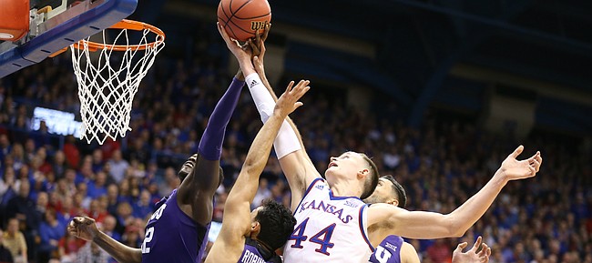 Kansas forward Mitch Lightfoot (44) fights for a ball with several TCU players during the first half on Tuesday, Feb. 6, 2018 at Allen Fieldhouse.
